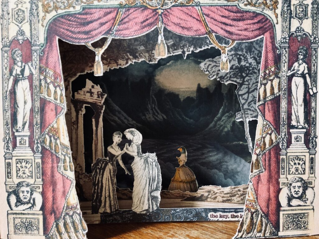 A pop up card which shows theatre curtains in pink, behind them two characters in edwardian dress (one with curled goat horns) clasp hands, behind them a woodland and ruined temple, behind that an other character with a bird head, stands before a moonscape background . Glimpsed text reads 'the key the kist'
